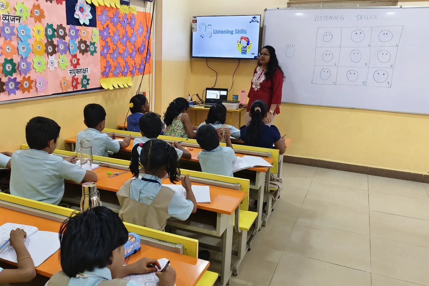 Shruti leading a listening activity with school students in a classroom